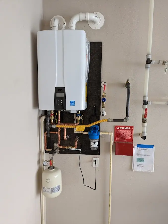 Professional plumber installing copper piping in a Walker home